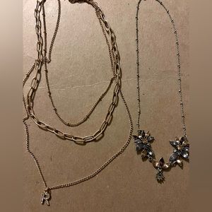2 necklaces. Gold with R letter and flower necklace